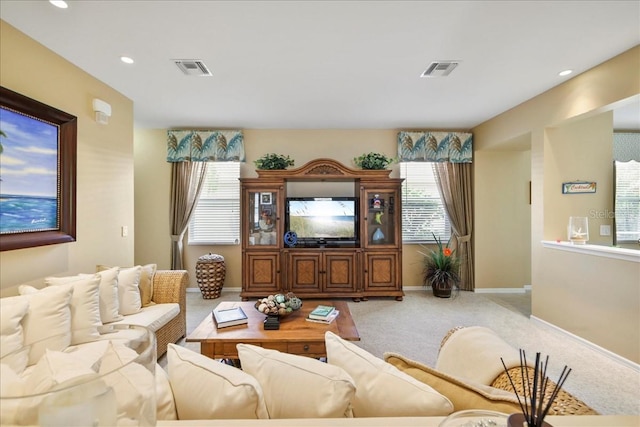 13180 SW Pembroke Cir N, Lake Suzy, FL 34269 - carpeted living room featuring plenty of natural light, baseboards, and recessed lighting