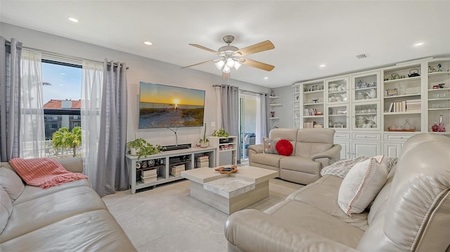 living room with ceiling fan and recessed lighting