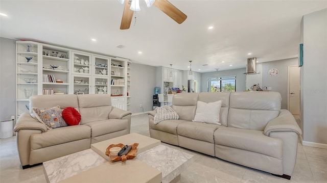 living room featuring ceiling fan, recessed lighting, and baseboards