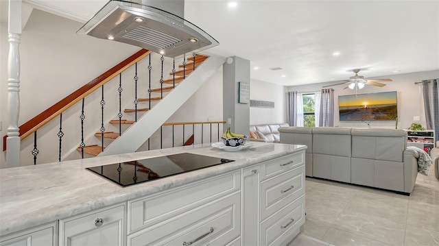 kitchen featuring black electric cooktop, open floor plan, a ceiling fan, white cabinets, and recessed lighting
