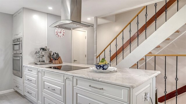 kitchen featuring island exhaust hood, black electric stovetop, white cabinetry, double oven, and recessed lighting