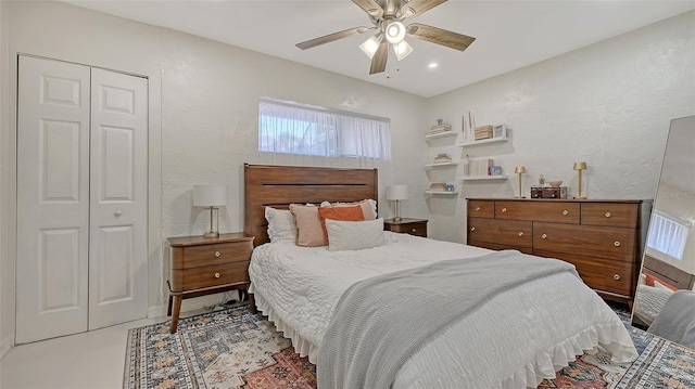 bedroom with multiple windows, ceiling fan, a closet, a textured wall, and recessed lighting