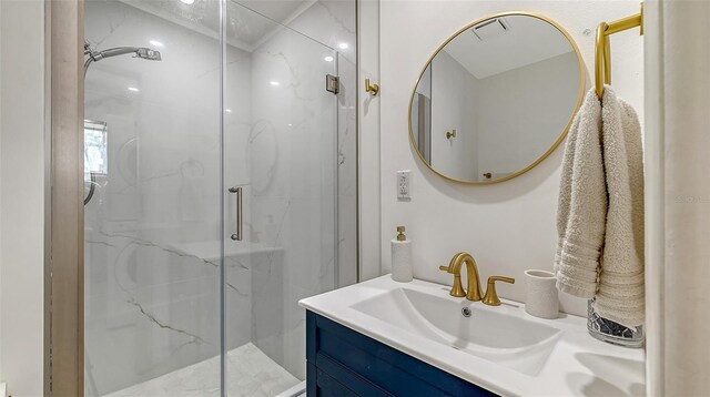 bathroom with a marble finish shower and vanity