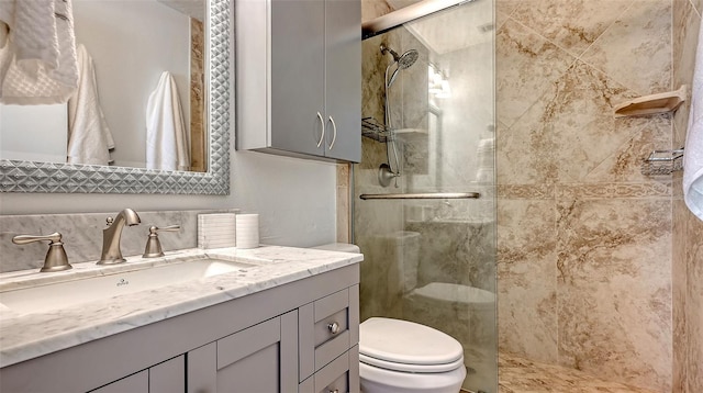 full bathroom with a stall shower, toilet, and vanity