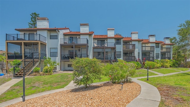view of property's community featuring a yard and stairs