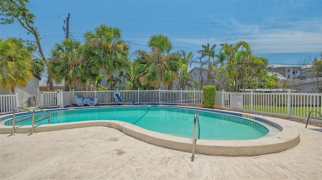 community pool featuring fence, a patio area, and central air condition unit