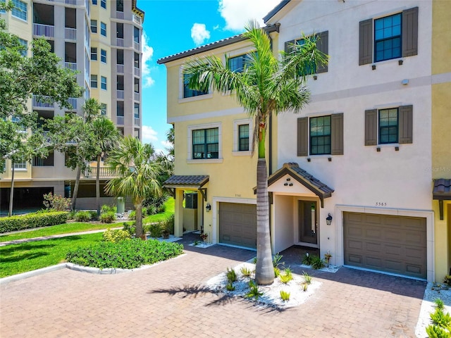 5561 Cannes Cir Unit 5101, Sarasota, FL 34231 - multi unit property featuring an attached garage, stucco siding, and driveway