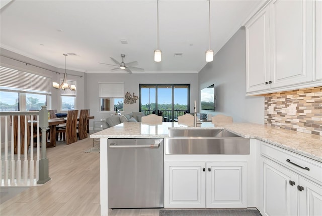 5561 Cannes Cir Unit 5101, Sarasota, FL 34231 - kitchen with dishwasher, backsplash, a peninsula, healthy amount of natural light, and ornamental molding