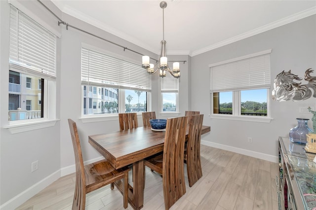 5561 Cannes Cir Unit 5101, Sarasota, FL 34231 - dining area with a chandelier, plenty of natural light, crown molding, baseboards, and light wood-style flooring