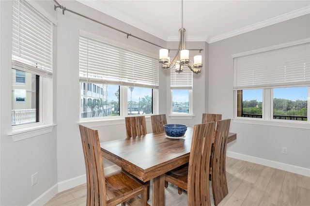 5561 Cannes Cir Unit 5101, Sarasota, FL 34231 - dining room with a chandelier, crown molding, baseboards, and light wood-type flooring