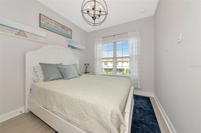 5561 Cannes Cir Unit 5101, Sarasota, FL 34231 - bedroom with a chandelier, baseboards, and wood finished floors