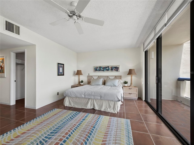 2120 Harbourside Dr Unit 617, Longboat Key, FL 34228 - tiled bedroom with a textured ceiling, a closet, ceiling fan, and baseboards