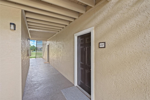 entrance to property featuring stucco siding