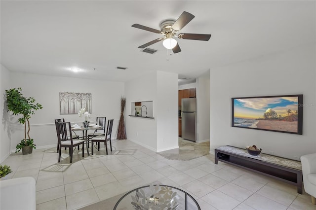 dining area featuring a ceiling fan, light tile patterned floors, and baseboards