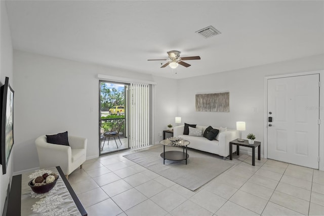 living room featuring ceiling fan, light tile patterned flooring, and baseboards