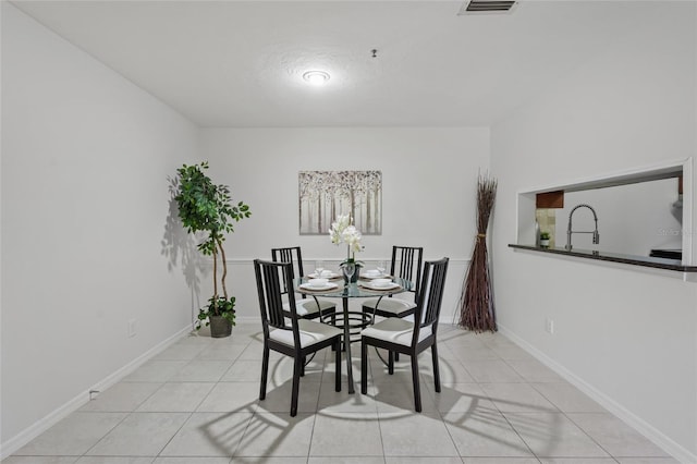 dining area with light tile patterned floors and baseboards