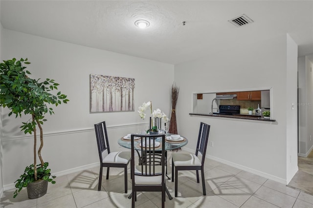 dining space with light tile patterned floors and baseboards