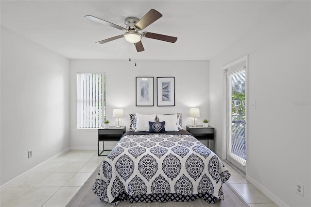 bedroom with light tile patterned flooring, baseboards, and a ceiling fan