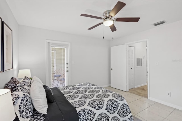 bedroom featuring baseboards, light tile patterned floors, and ceiling fan