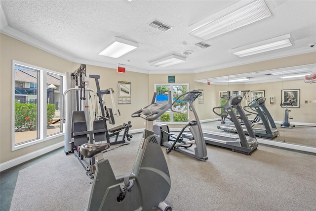 gym with ornamental molding, a textured ceiling, and baseboards