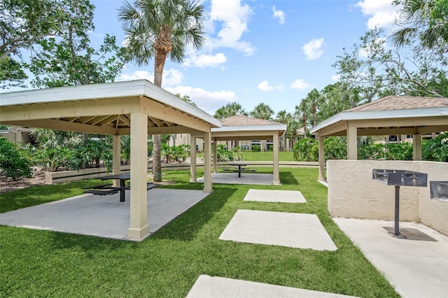 surrounding community with a gazebo and a yard