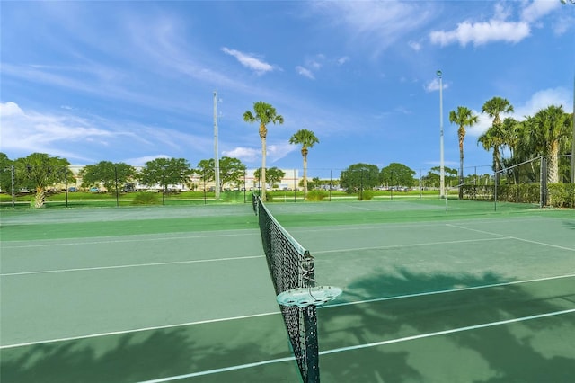 view of tennis court featuring fence
