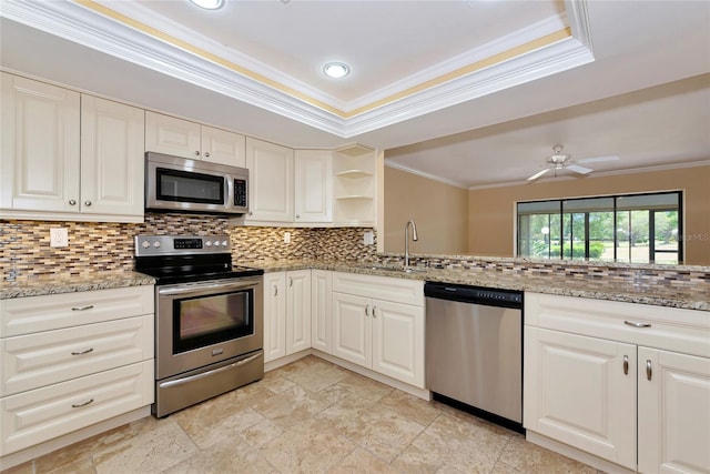 4471 Atwood Cay Cir Unit 13, Sarasota, FL 34233 - kitchen featuring stainless steel appliances, a sink, ornamental molding, open shelves, and decorative backsplash