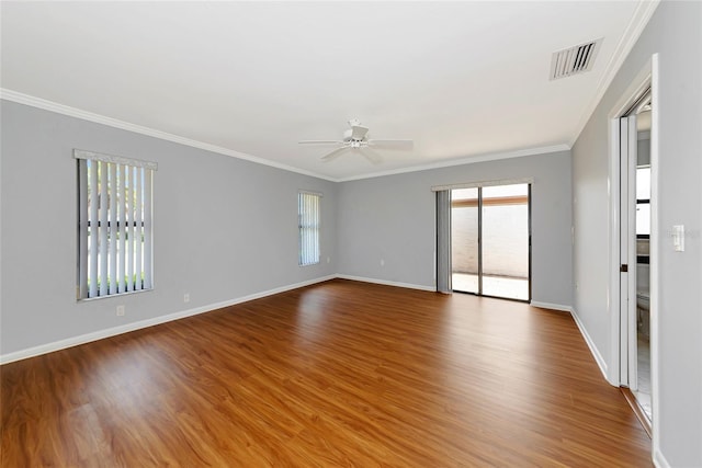 4471 Atwood Cay Cir Unit 13, Sarasota, FL 34233 - empty room featuring plenty of natural light, ceiling fan, crown molding, wood finished floors, and baseboards