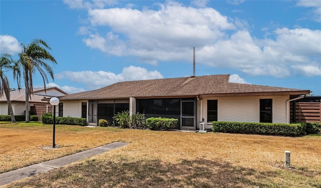 4471 Atwood Cay Cir Unit 13, Sarasota, FL 34233 - view of front facade with a sunroom and a front yard