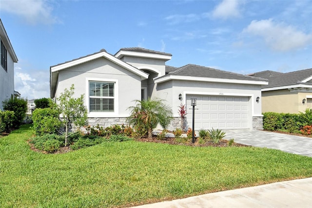 view of front of home featuring a garage, decorative driveway, stone siding, and stucco siding