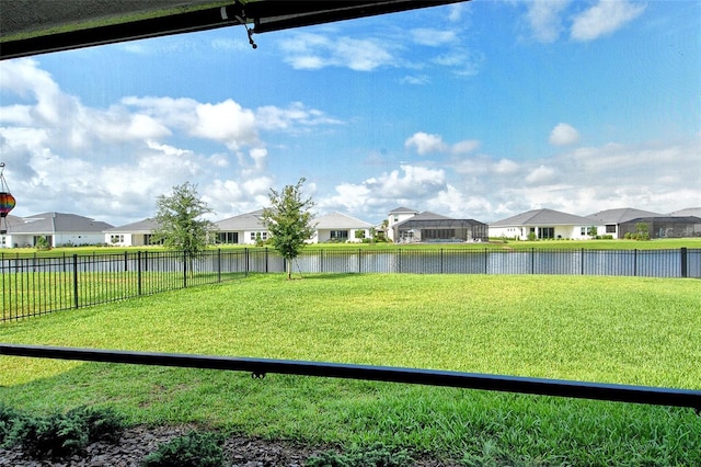 view of yard with a residential view and a water view