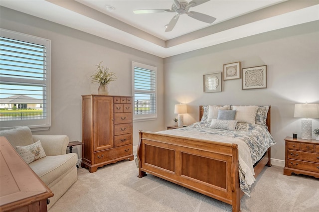 bedroom with light carpet, a ceiling fan, and baseboards