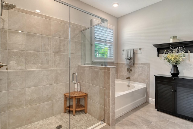 full bathroom with a garden tub, a shower stall, and tile patterned flooring