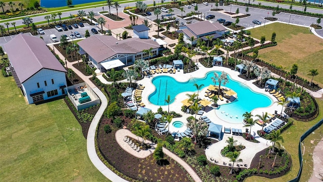 aerial view of property and surrounding area featuring a pool area