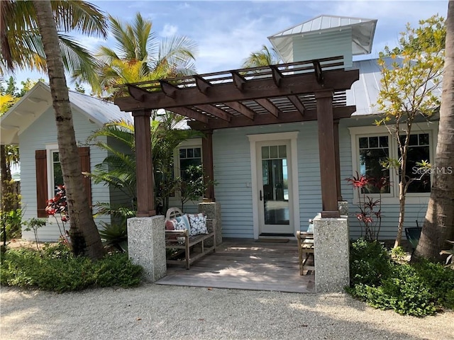 102 48th St, Holmes Beach, FL 34217 - back of house with a pergola