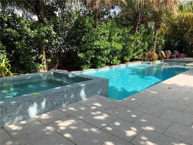 102 48th St, Holmes Beach, FL 34217 - view of swimming pool with a patio and a pool with connected hot tub
