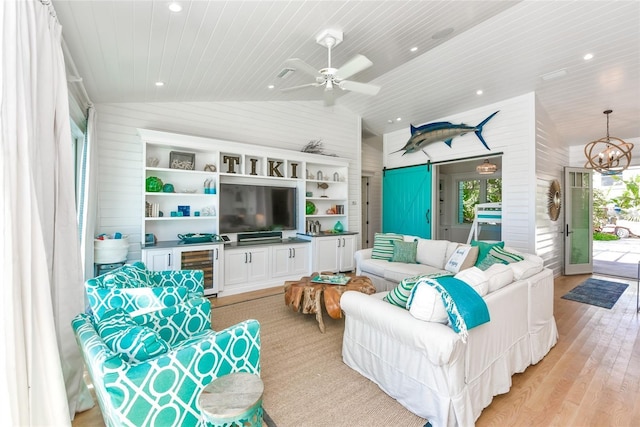 102 48th St, Holmes Beach, FL 34217 - living room with vaulted ceiling, wood ceiling, light wood-type flooring, wooden walls, and a chandelier
