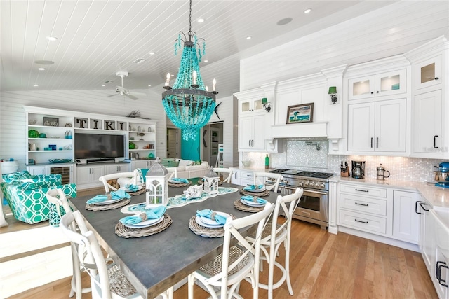 102 48th St, Holmes Beach, FL 34217 - dining area with light wood-style floors, vaulted ceiling, wood ceiling, a chandelier, and a ceiling fan