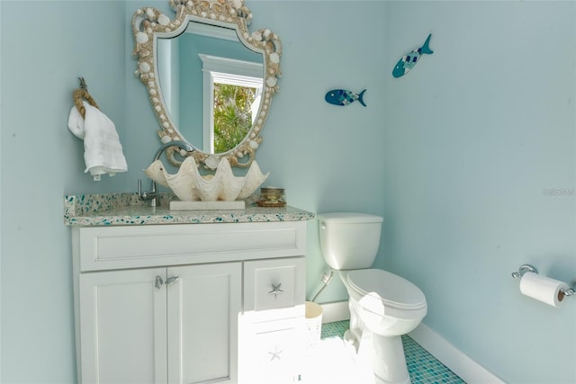 102 48th St, Holmes Beach, FL 34217 - half bath with toilet, vanity, baseboards, and tile patterned floors