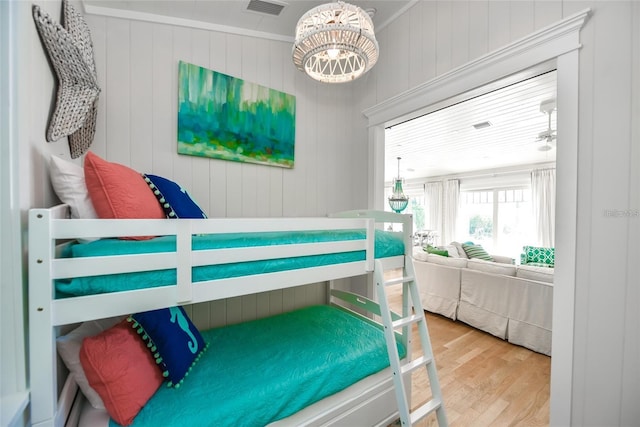 102 48th St, Holmes Beach, FL 34217 - bedroom featuring wood finished floors and a chandelier