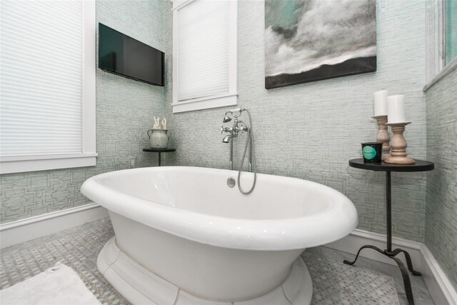 102 48th St, Holmes Beach, FL 34217 - bathroom featuring a soaking tub, baseboards, and tile patterned floors