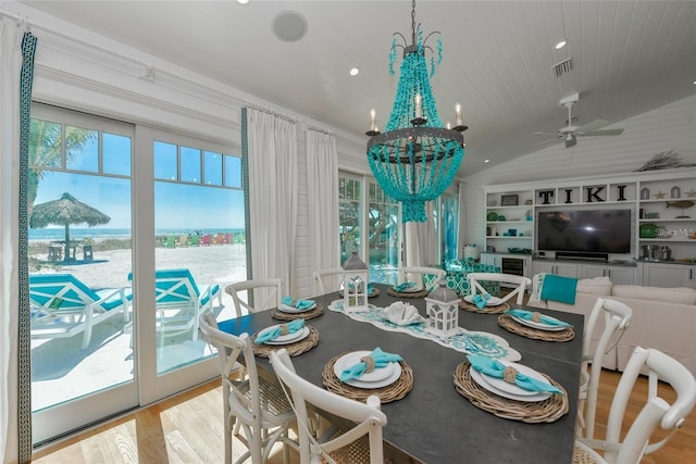 102 48th St, Holmes Beach, FL 34217 - dining space featuring wood finished floors, a water view, a chandelier, recessed lighting, and a ceiling fan