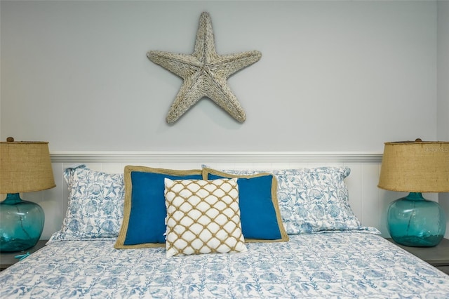 102 48th St, Holmes Beach, FL 34217 - bedroom featuring a wainscoted wall and a decorative wall