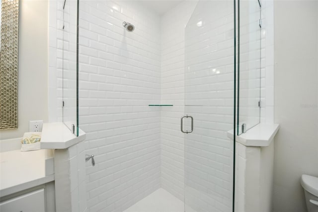 102 48th St, Holmes Beach, FL 34217 - bathroom with a stall shower, toilet, and vanity