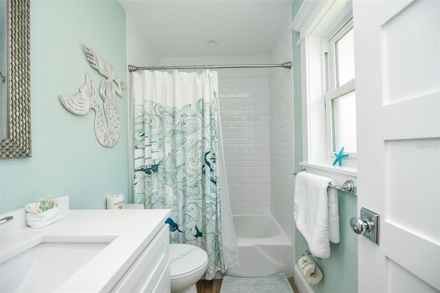 102 48th St, Holmes Beach, FL 34217 - bathroom featuring toilet, shower / bath combo with shower curtain, and vanity