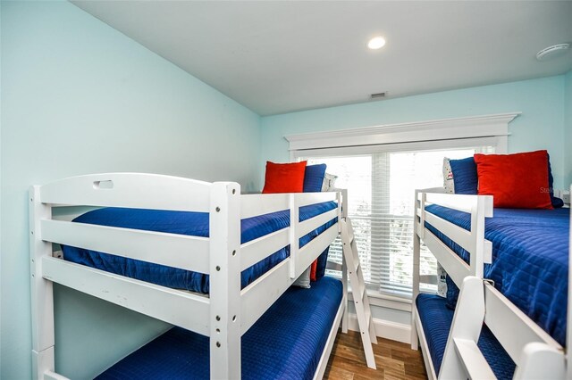 102 48th St, Holmes Beach, FL 34217 - bedroom with wood finished floors and multiple windows