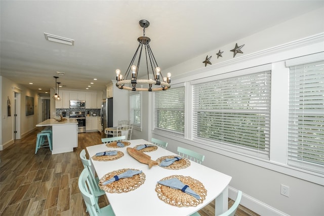 102 48th St, Holmes Beach, FL 34217 - dining room with a chandelier, baseboards, dark wood-style flooring, and recessed lighting
