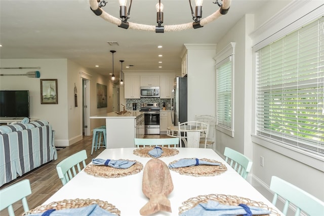 102 48th St, Holmes Beach, FL 34217 - dining space with dark wood-style floors, baseboards, and recessed lighting