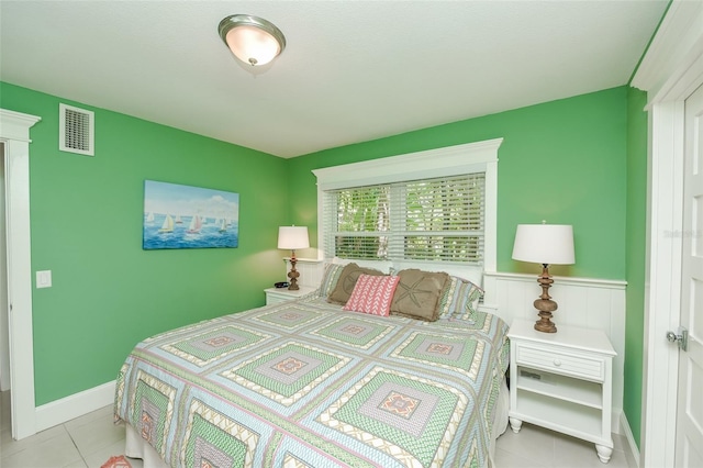 102 48th St, Holmes Beach, FL 34217 - tiled bedroom with a wainscoted wall