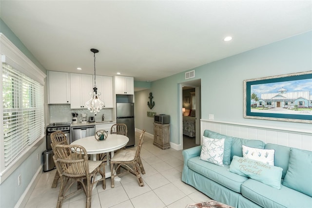 102 48th St, Holmes Beach, FL 34217 - dining area with light tile patterned floors, baseboards, and recessed lighting